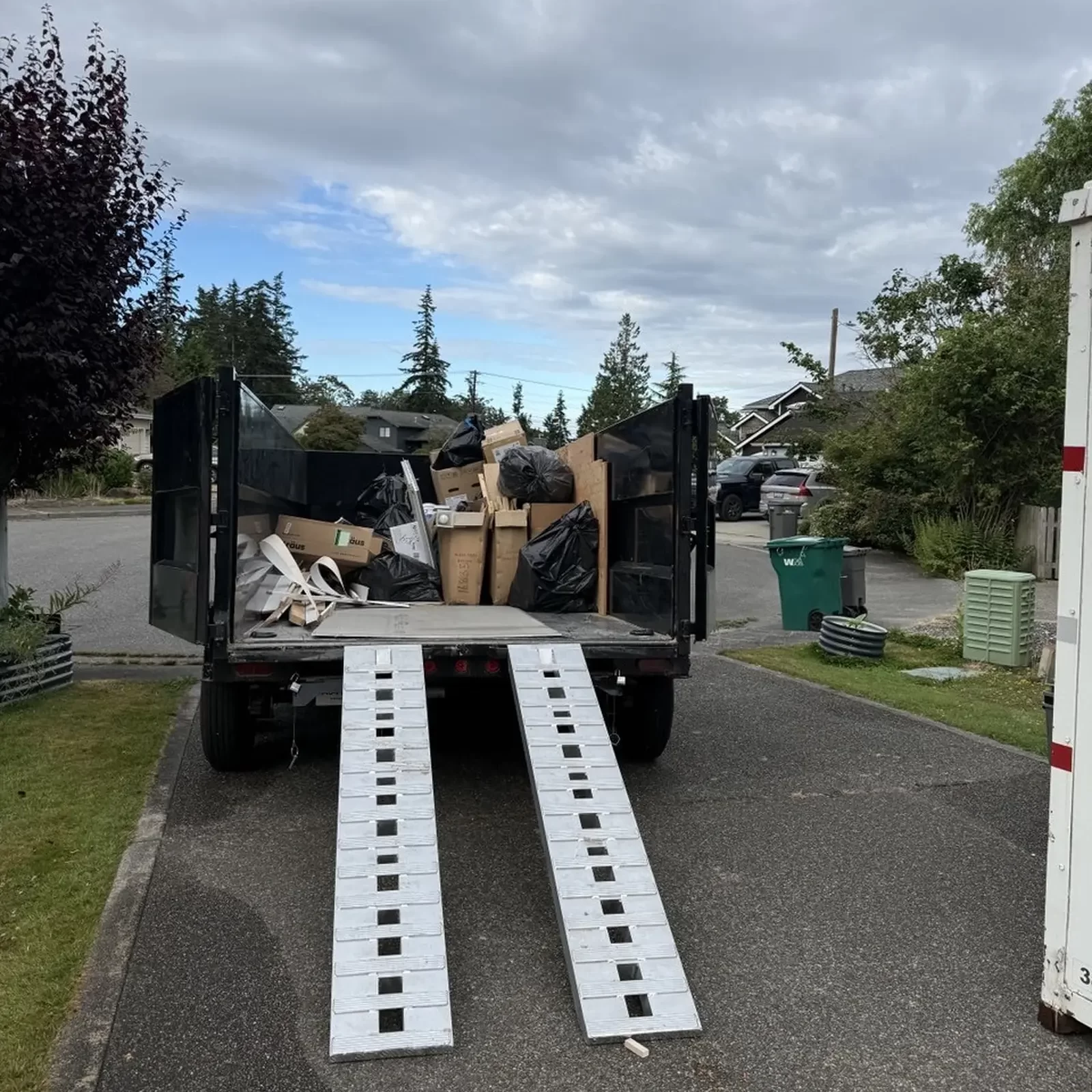 Loading commercial construction debris into a dump trailer.