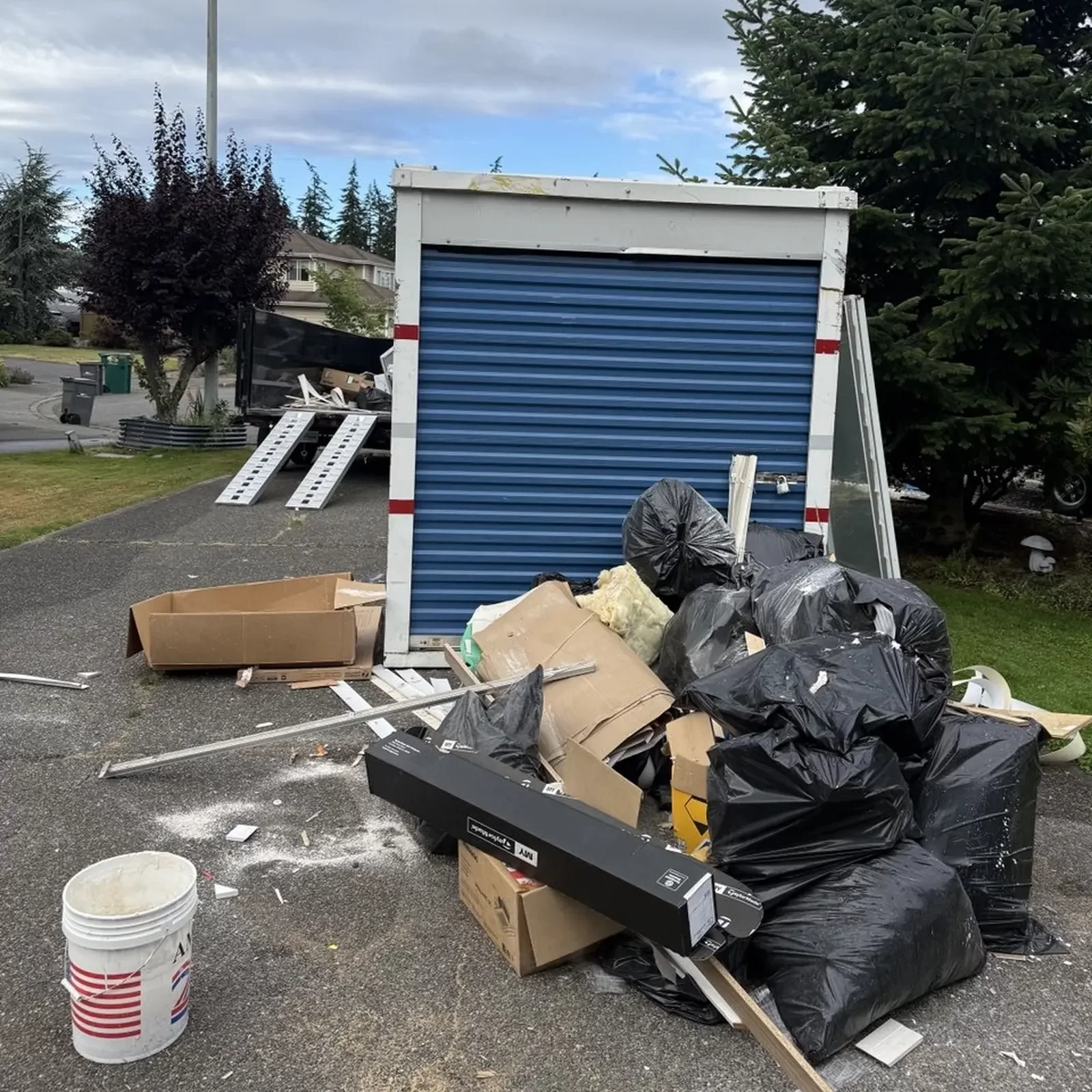 Loading commercial construction debris into a dump trailer.