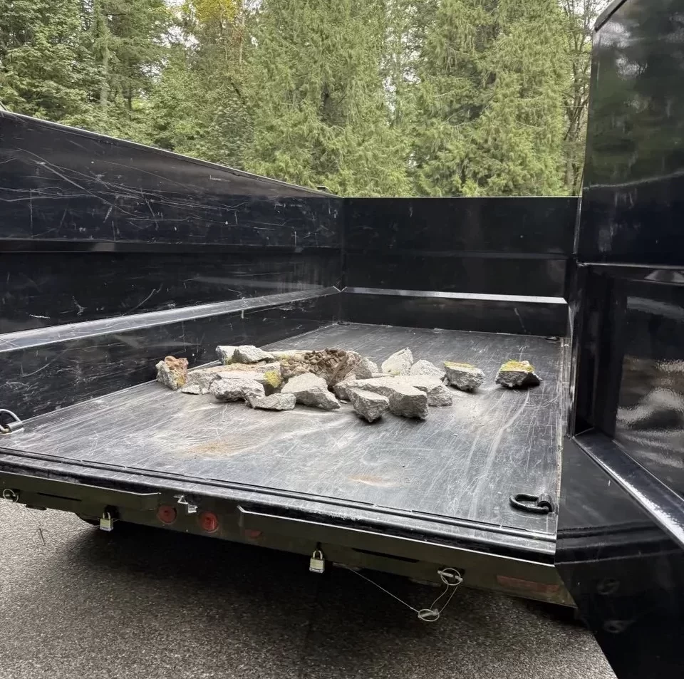 Broken concrete pieces loaded into a dump trailer for haul-away