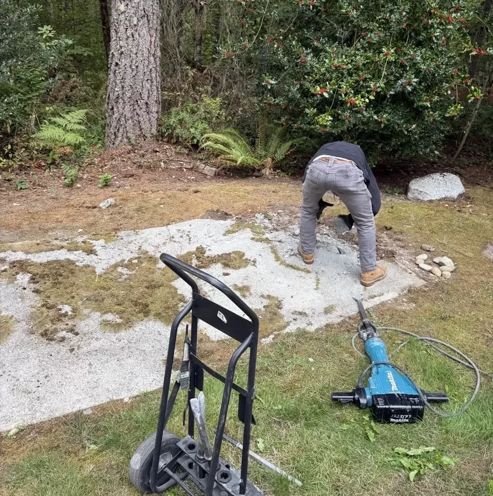Worker breaking up a concrete slab in Redmond